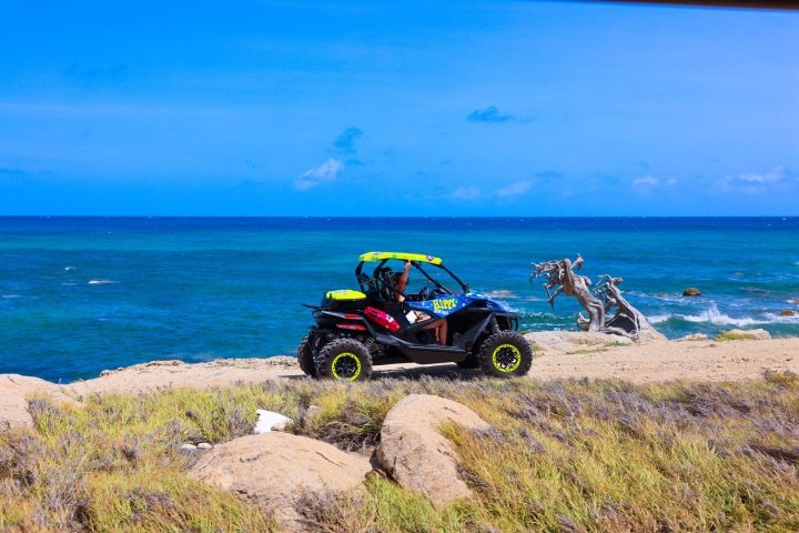 a motorcycle that is sitting on a rocky beach