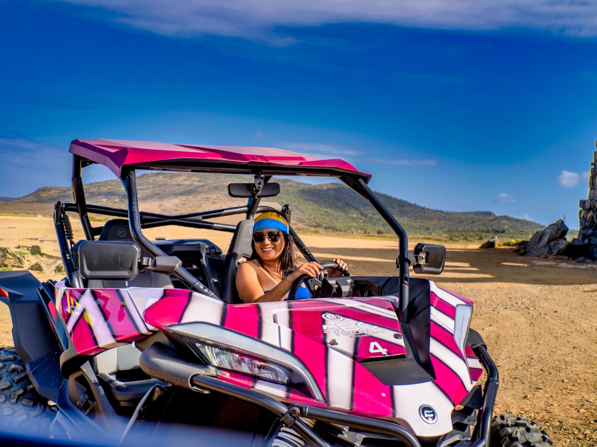 a woman in a UTV on a dirt path